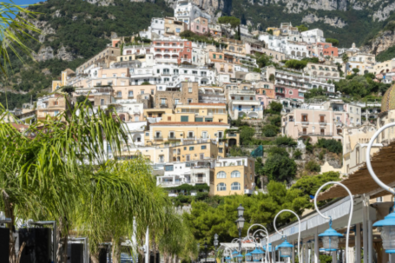 An ExcursionPass archive photograph shows Positano's dense vertical settlement from across the slope.