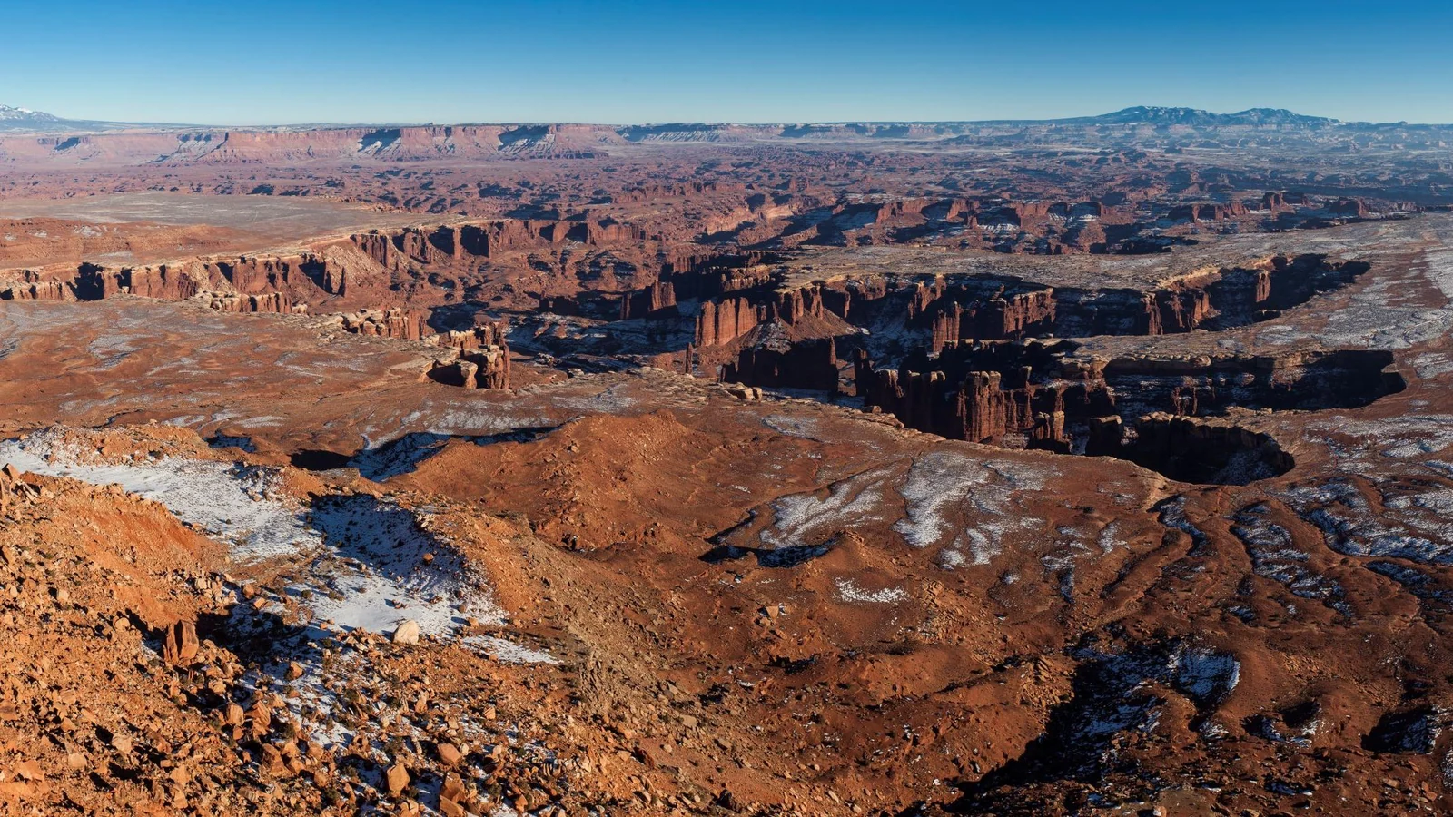 Snow dusts the stepped canyon landscape and White Rim bench below Grand View Point.