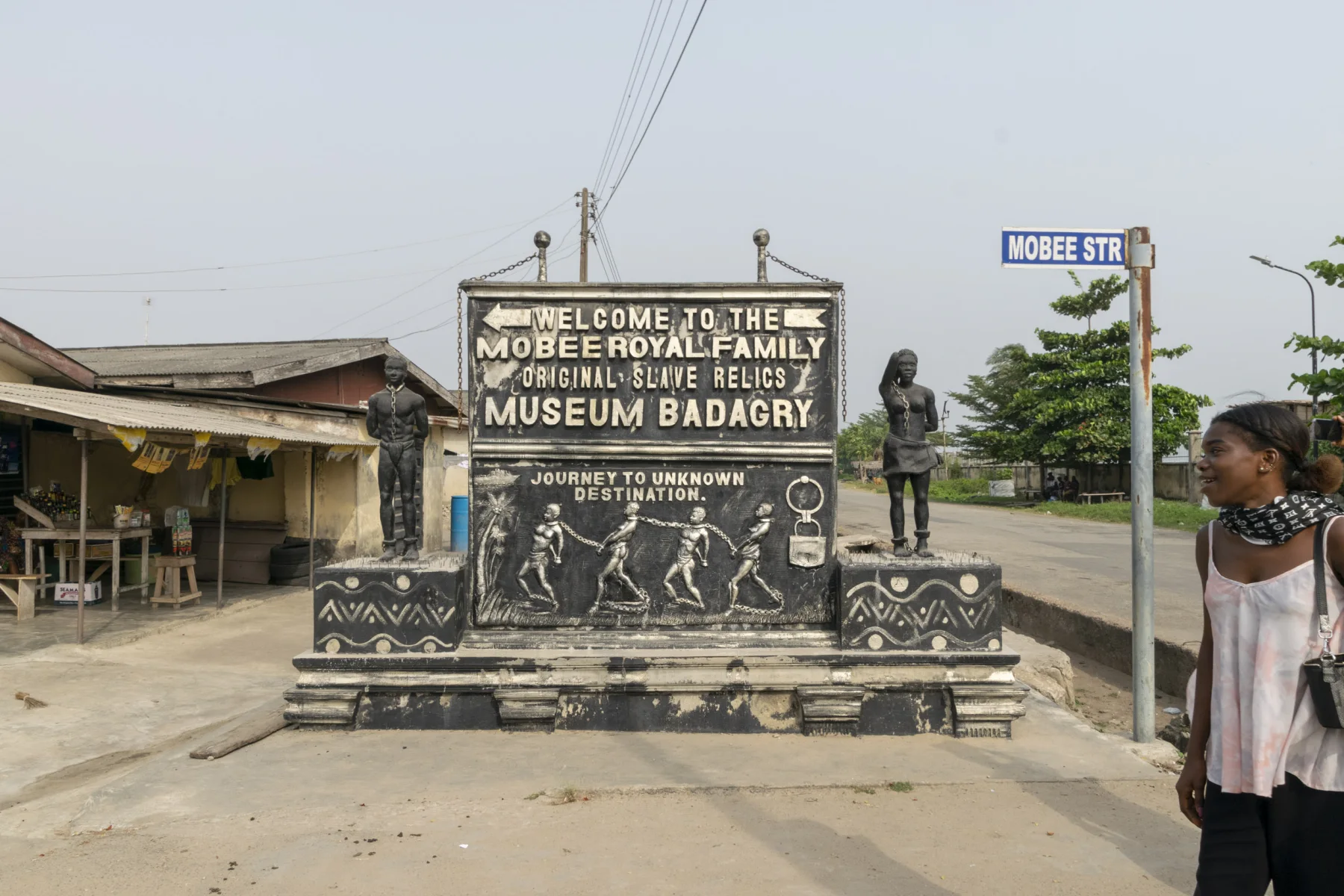 A sign and sculptural figure mark the Mobee Royal Family Slave Relics Museum.