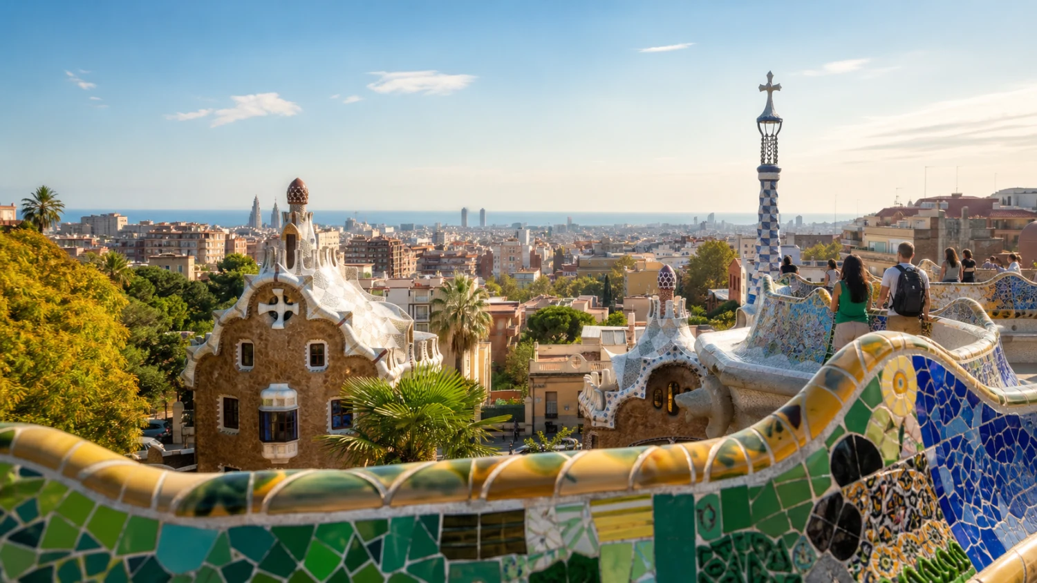 Park Güell’s serpentine bench frames the Porter’s Lodge pavilions and Barcelona