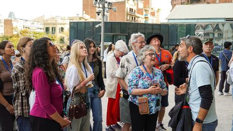 A certified guide speaks with a small group outside the Sagrada Família