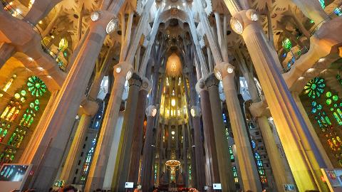 Branching columns and coloured stained glass inside the nave of the Sagrada Família