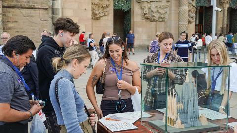 Visitors gather around an architectural model display at the Sagrada Família