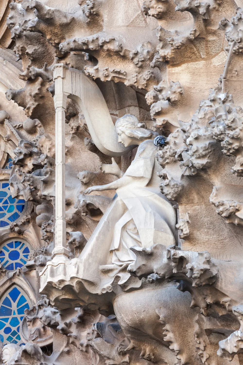 A vertical detail of the Nativity Façade’s Charity Portal shows how figure, foliage and stone architecture occupy the same surface