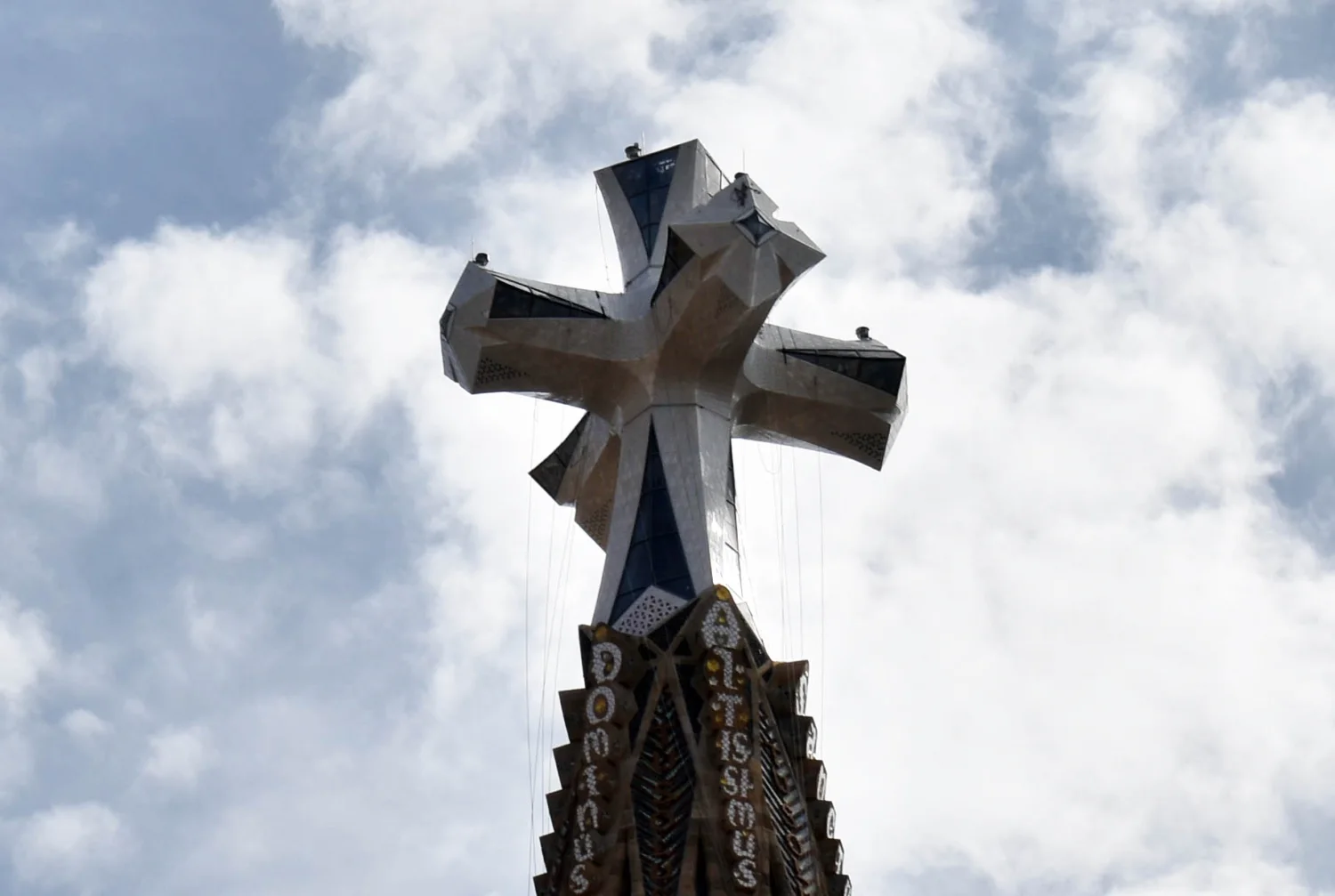 The four-armed cross crowns the newly completed exterior of the Tower of Jesus Christ in May 2026