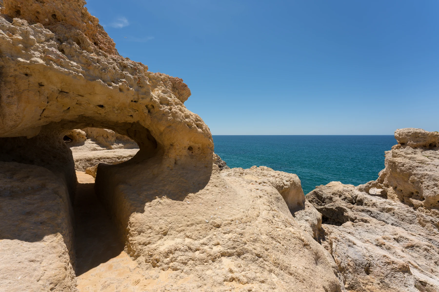 Weathered limestone cavities and rock terraces at Algar Seco beside the Atlantic, photographed in 2020