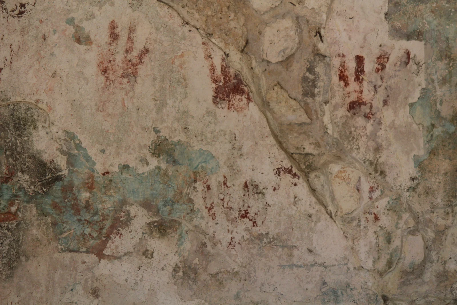 Red handprints and surviving painted plaster remain visible inside Las Manitas at San Gervasio.