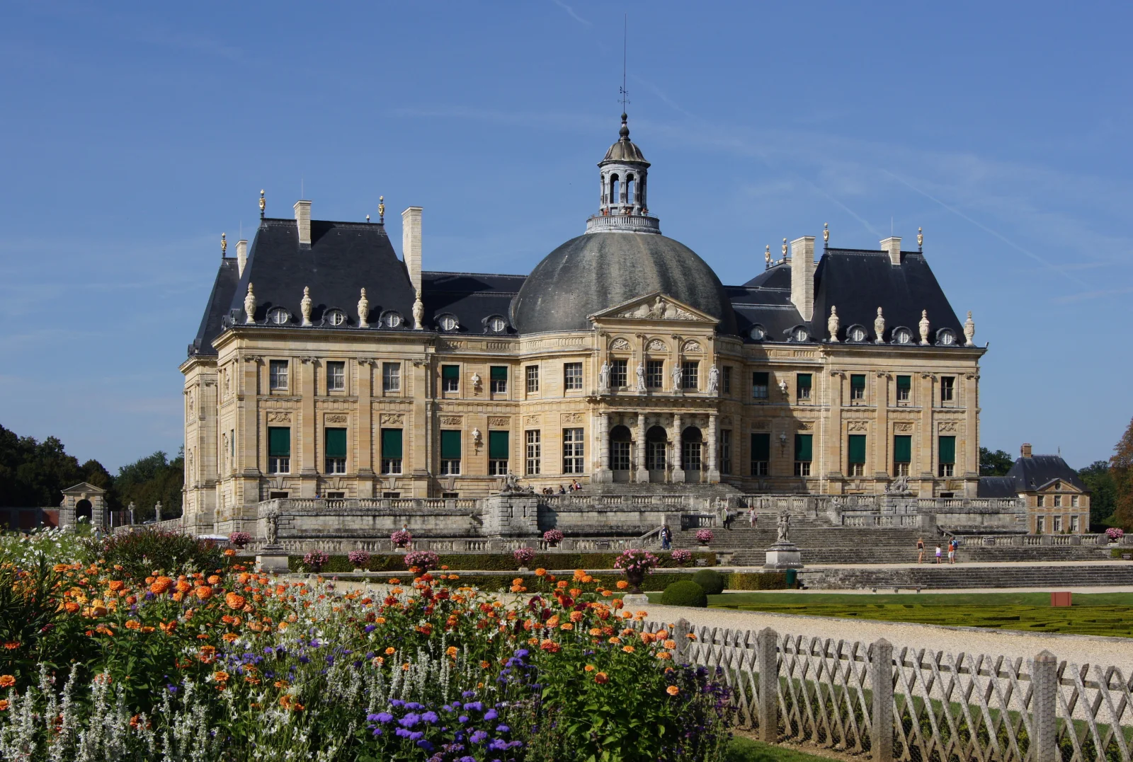 The garden façade of Vaux-le-Vicomte rises behind terrace levels, parterres and planted edges.