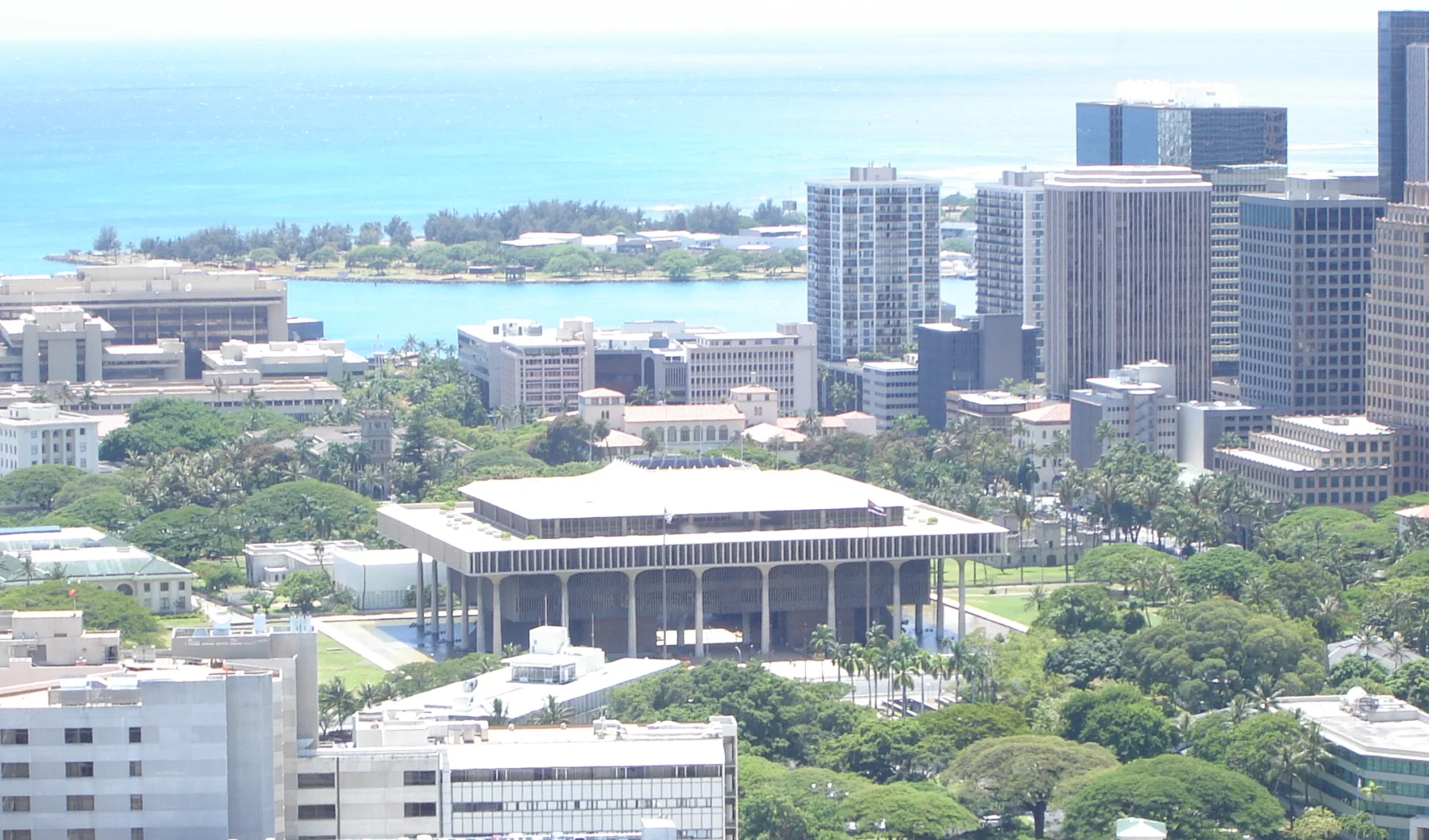 The Hawaiʻi State Capitol viewed from Puowaina/Punchbowl, with the civic district and ocean beyond.
