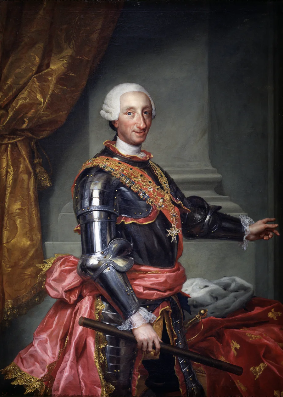 Anton Raphael Mengs’s formal portrait shows Charles III standing beside a crown and symbols of command.