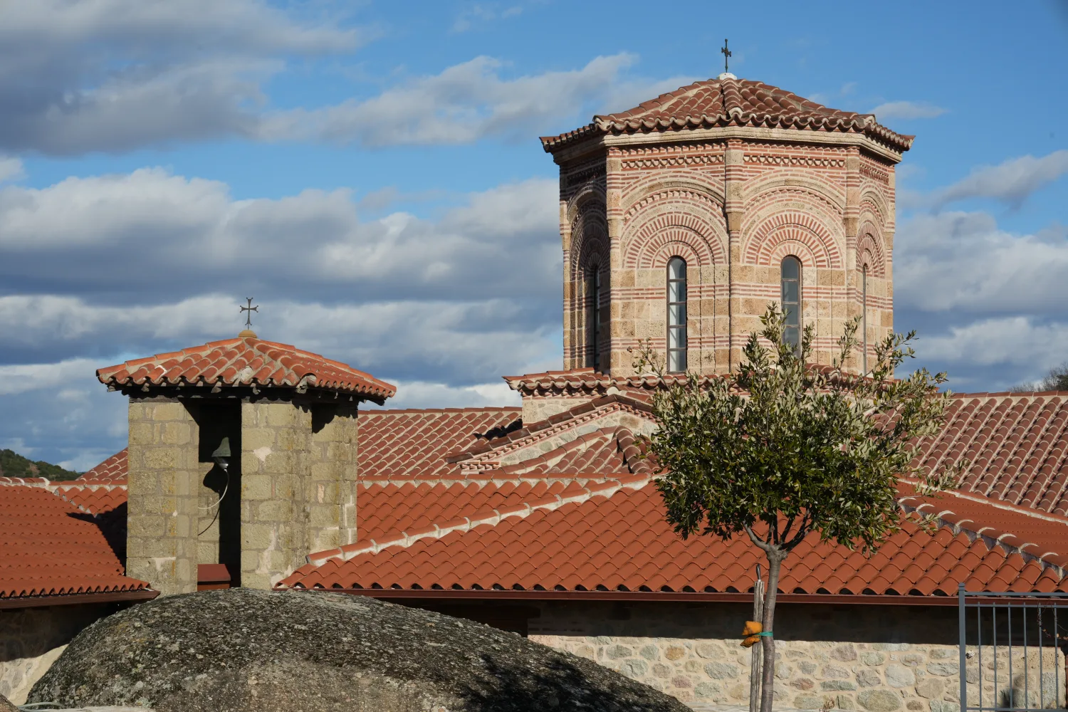 Holy Trinity Monastery appearing almost embedded in a tall isolated tower.