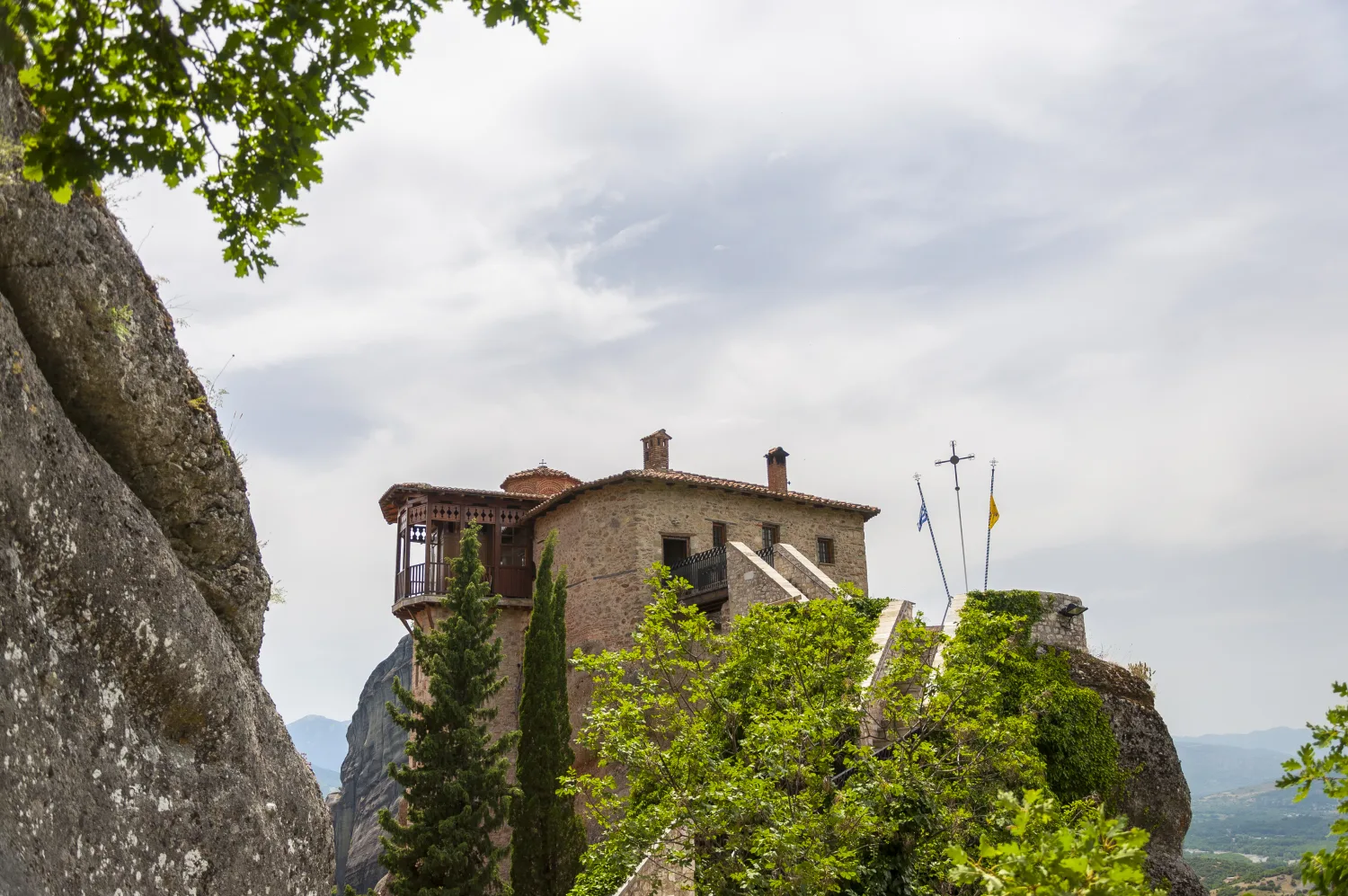Rousanou Monastery wrapped around the narrow top of a steep rock.