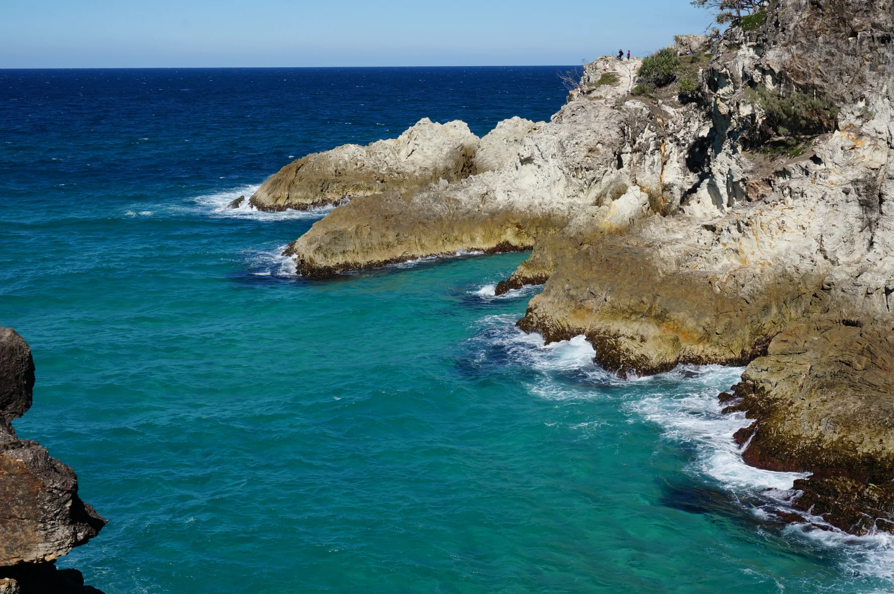 Rocky walls and ocean water meet beneath the North Gorge walking route.