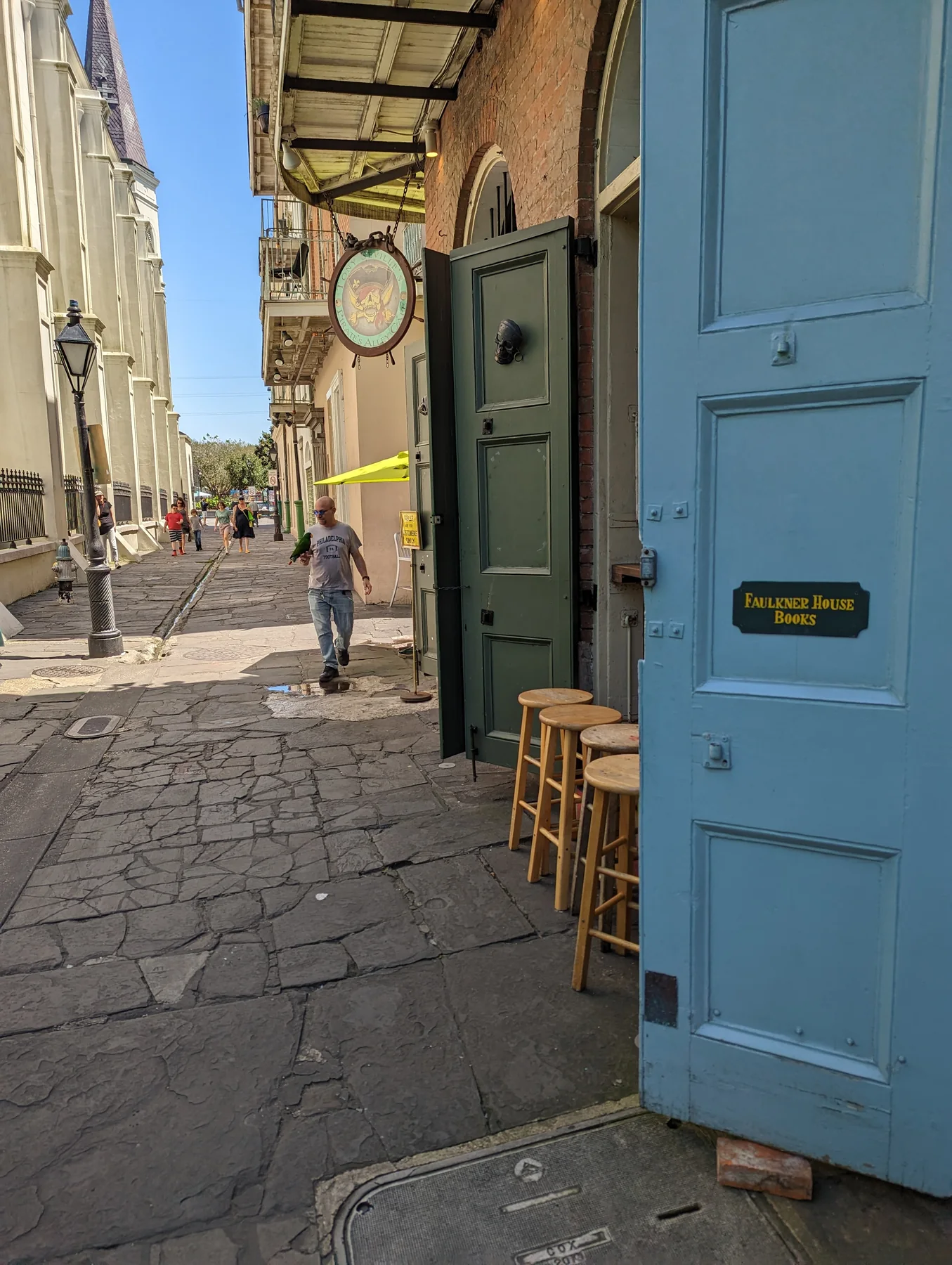 Pirate’s Alley narrows between the cathedral and commercial doors near the Faulkner House