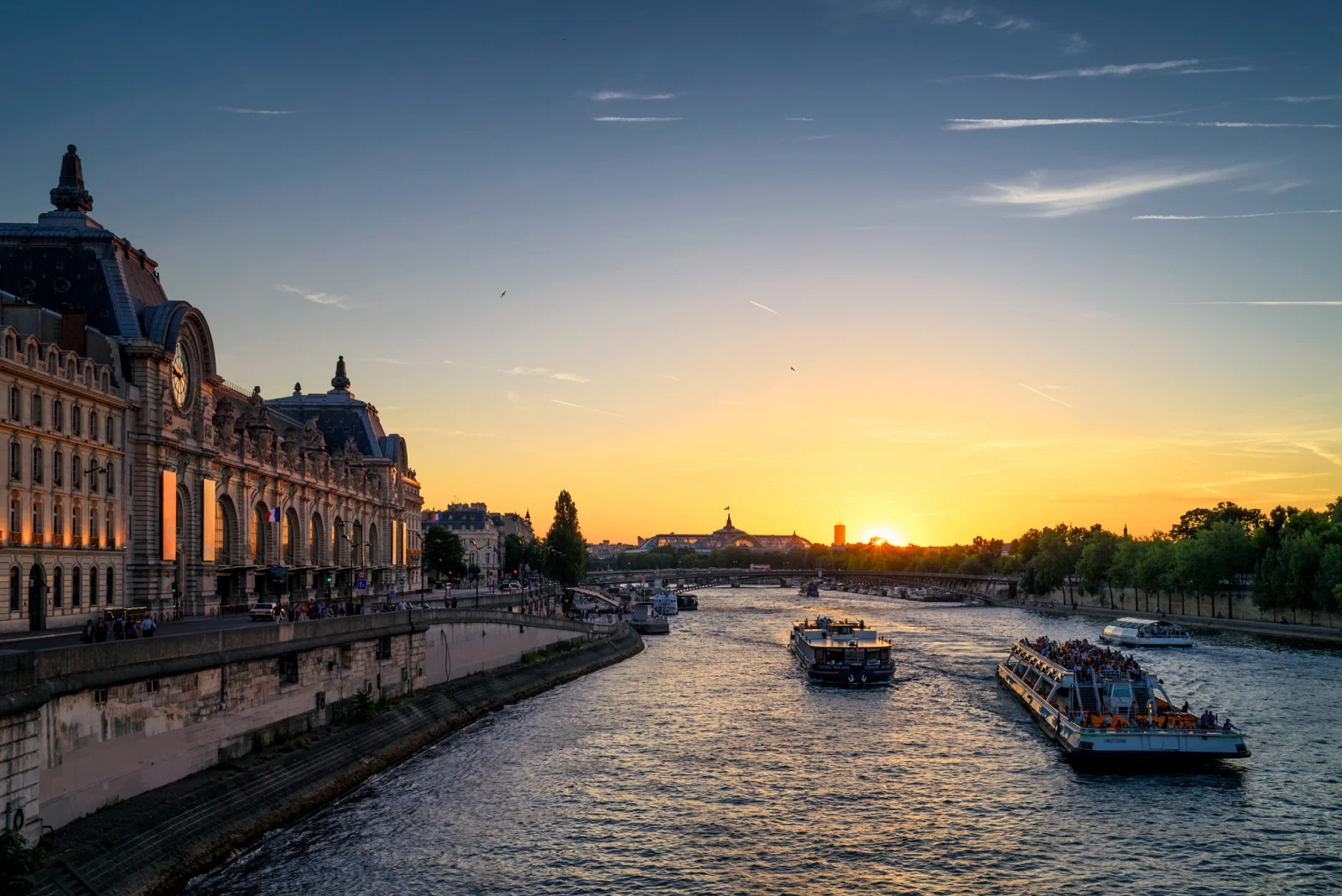 The Musée d’Orsay’s river façade and great clock beside the Seine at sunset.