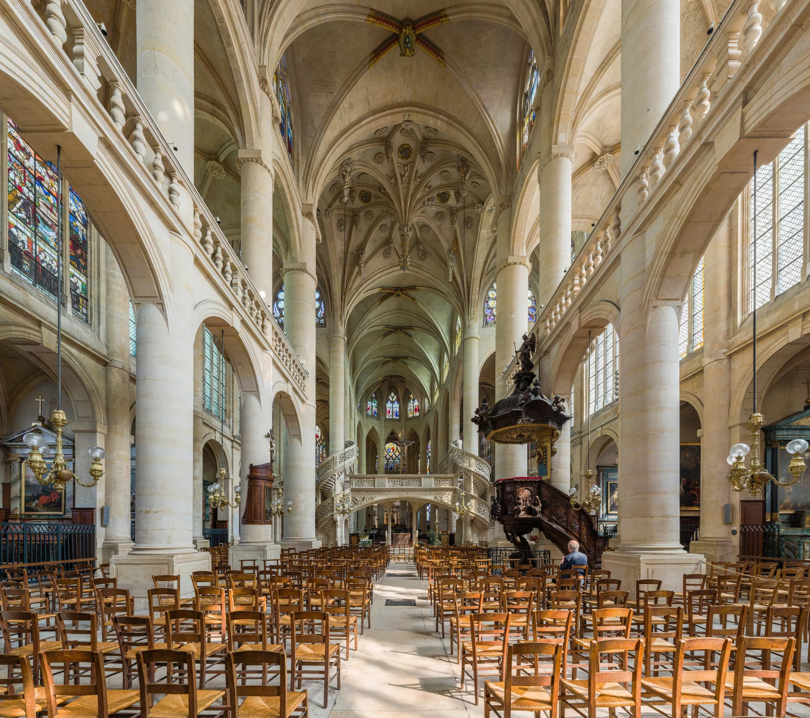 The nave of Saint-Étienne-du-Mont shows the pale stone jubé spanning the choir, with two delicate spiral stairs wrapping the supports.