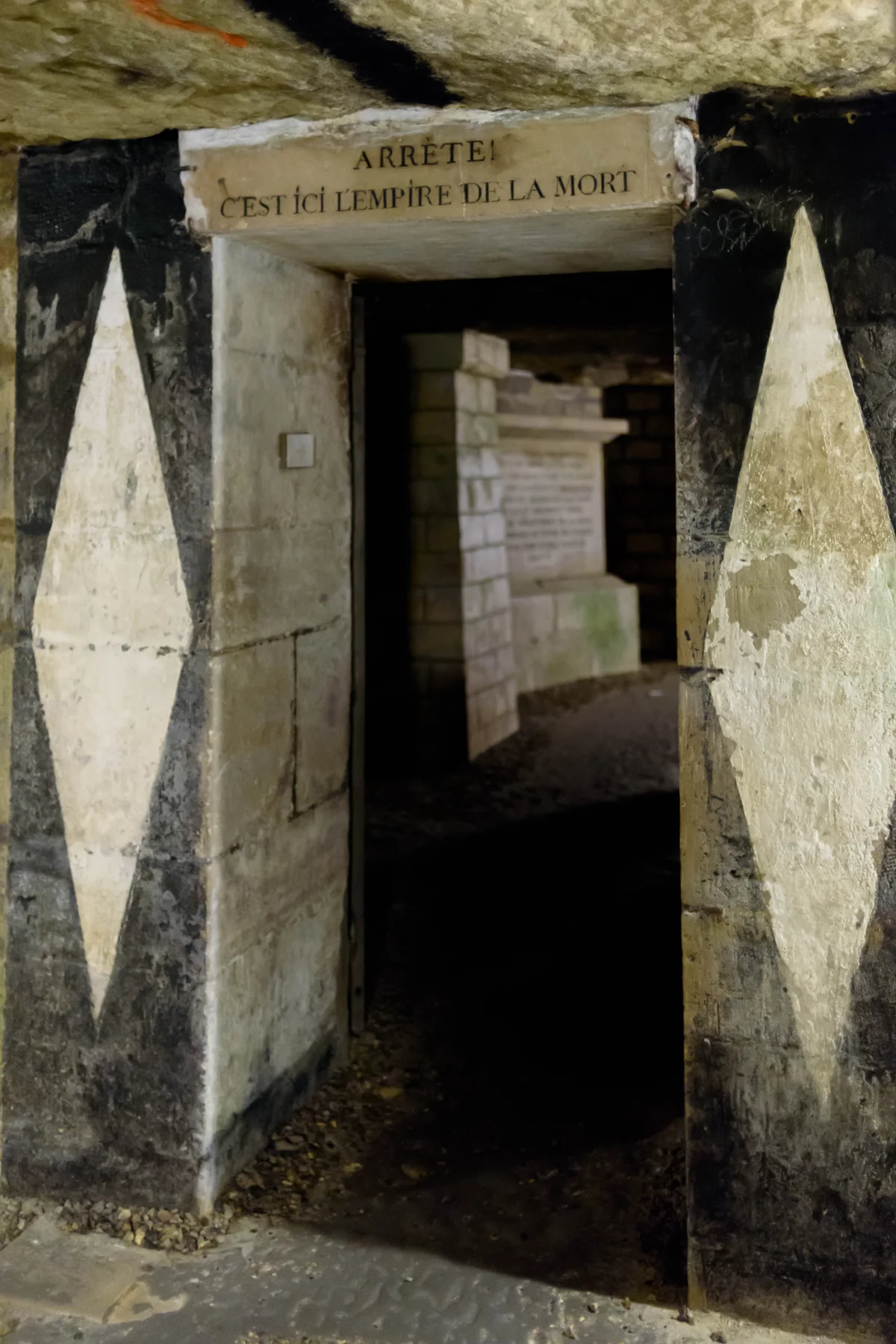 The threshold inside the ossuary bears the French warning that this is the empire of death.