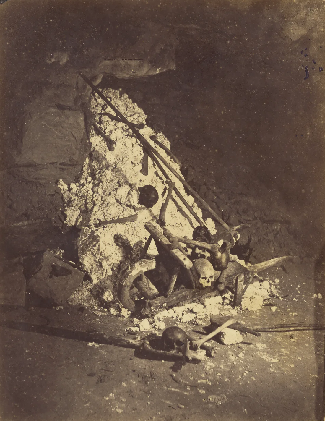 Nadar's 1862 photograph records a loose deposit of human remains and quarry material in the Catacombs.