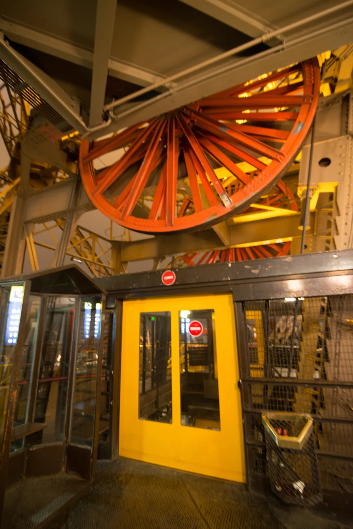 A modern inclined elevator moving through one of the Eiffel Tower's lattice piers.