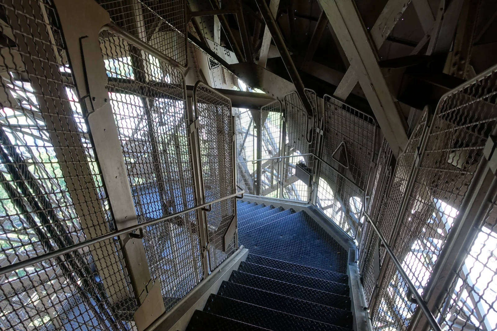 The public stairs crossing the iron lattice on the way to the first floor.