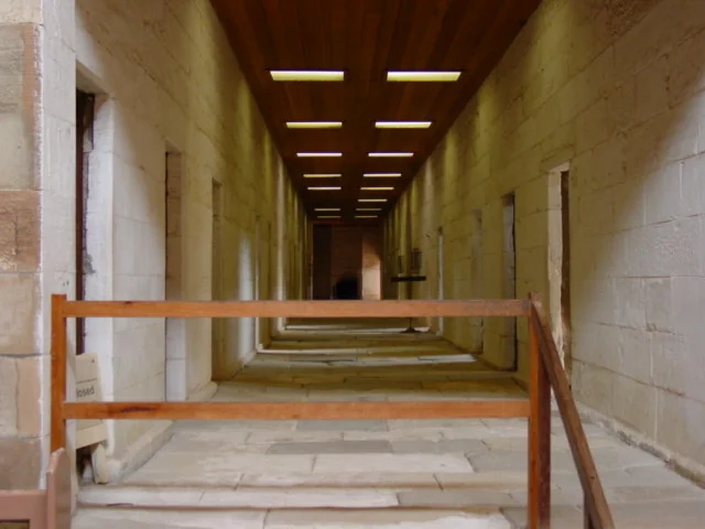 A surviving corridor and cell doors show the repetitive interior order of the Separate Prison.