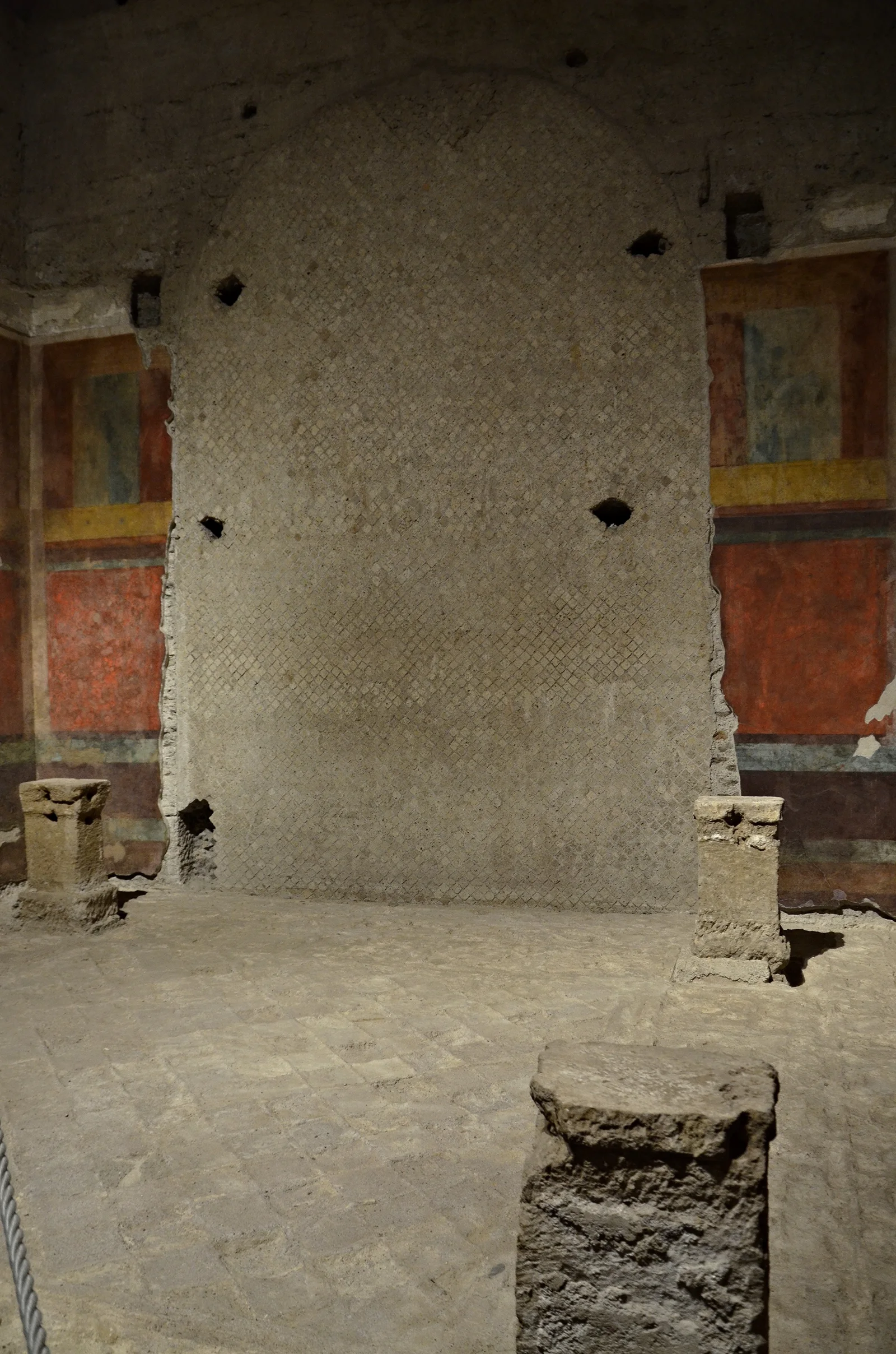 Fragments of Second Style wall painting survive around exposed plaster in the House of Augustus.
