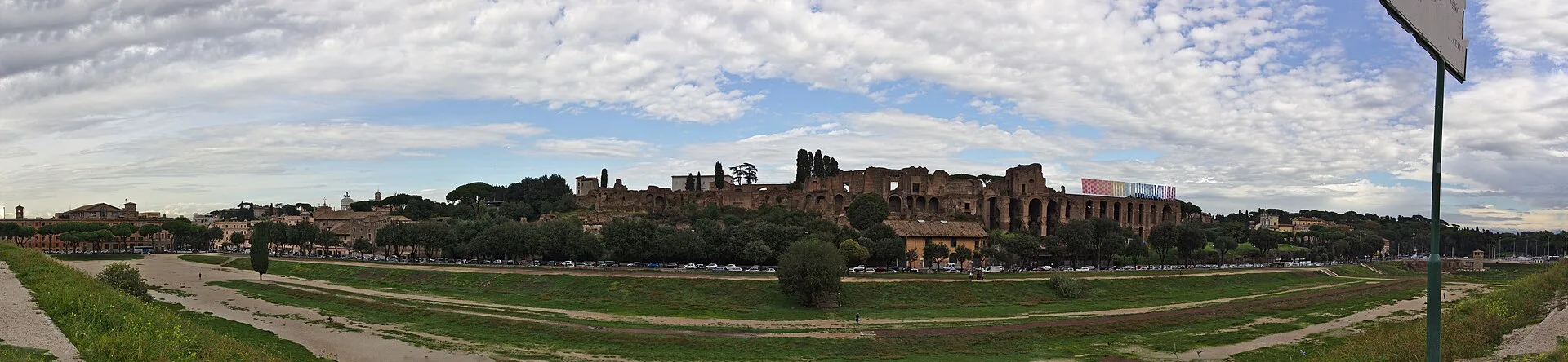 A panoramic view across Circus Maximus shows its elongated floor between modern Rome and the Palatine slope.