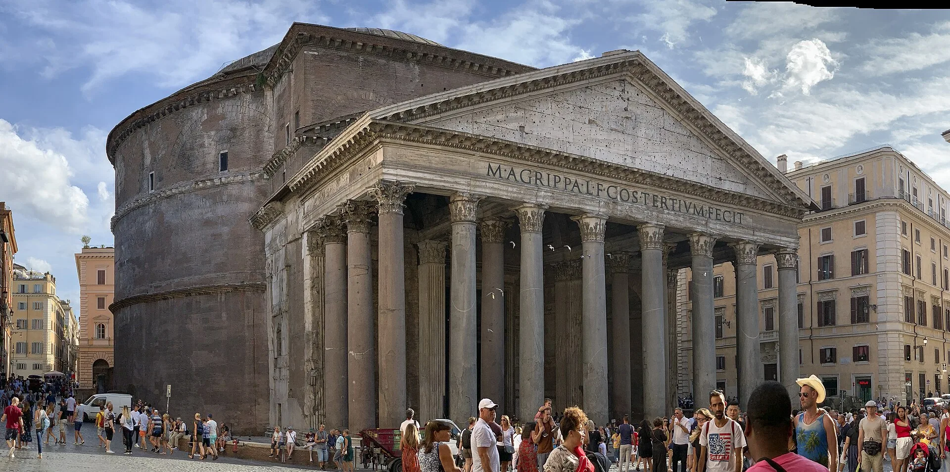 The Pantheon portico and rotunda preside over Piazza della Rotonda while visitors occupy the fountain and square.