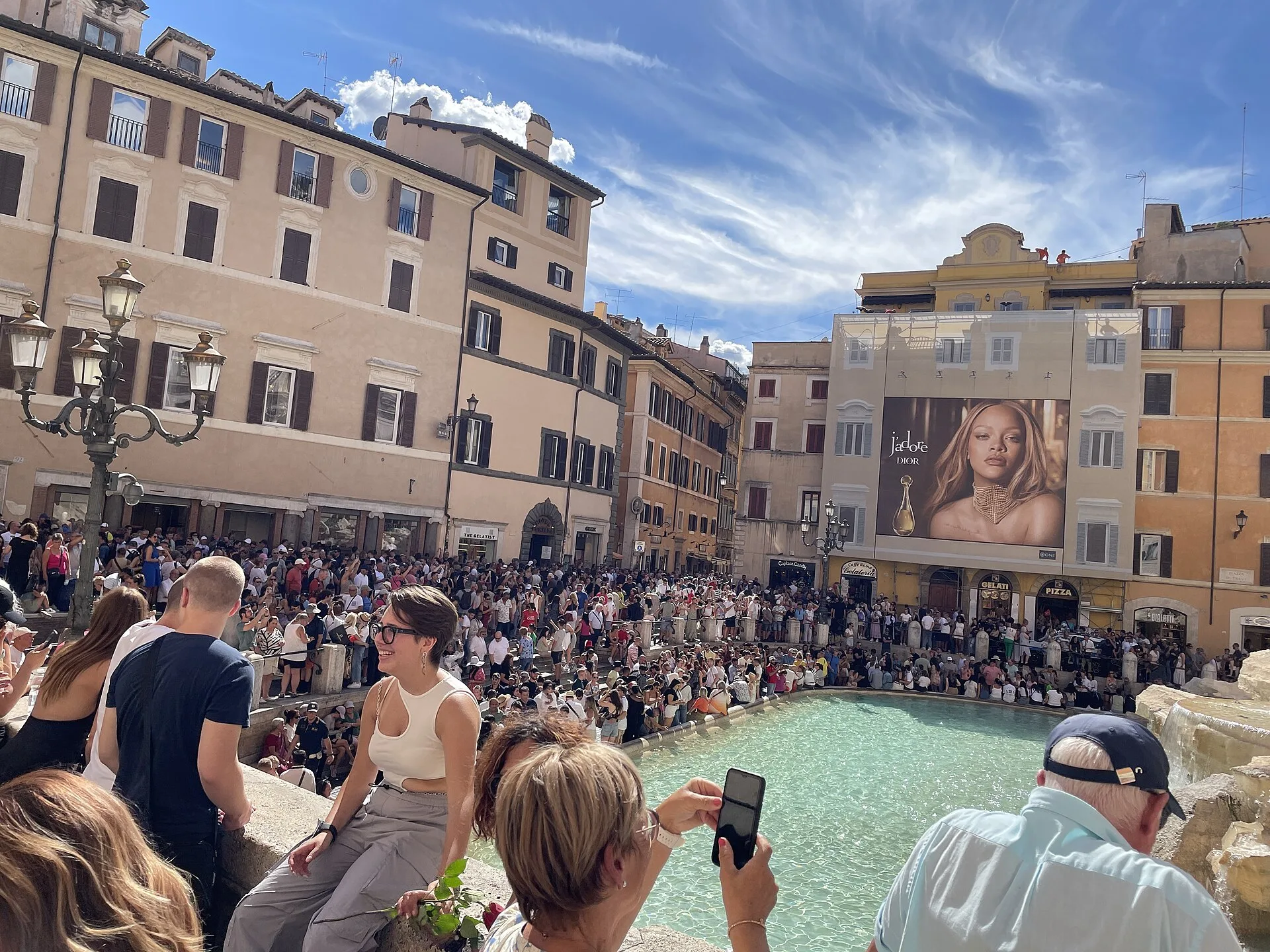 A dense crowd gathers around Trevi Fountain before the present basin-area access system.