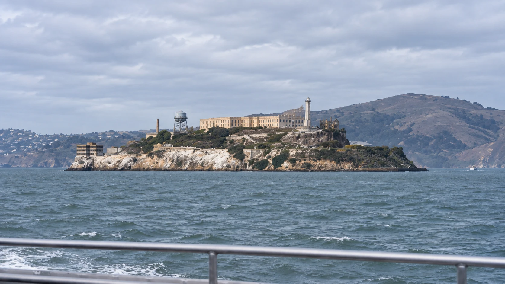 Alcatraz Island seen from its southern ferry approach, with Marin hills beyond the Cellhouse and lighthouse