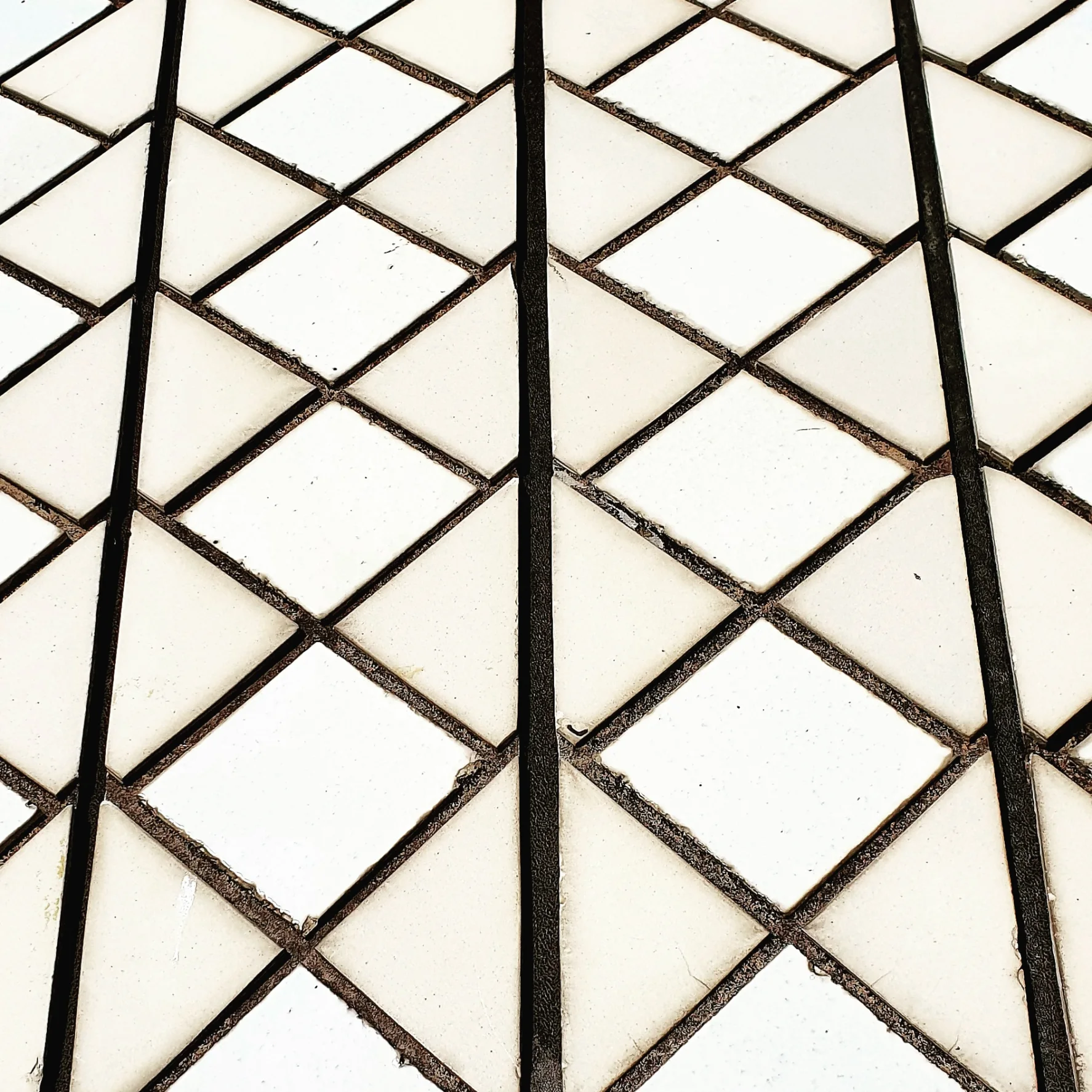 A close view of the Opera House tile pattern shows cream and white ceramic units organised across the curved surface.