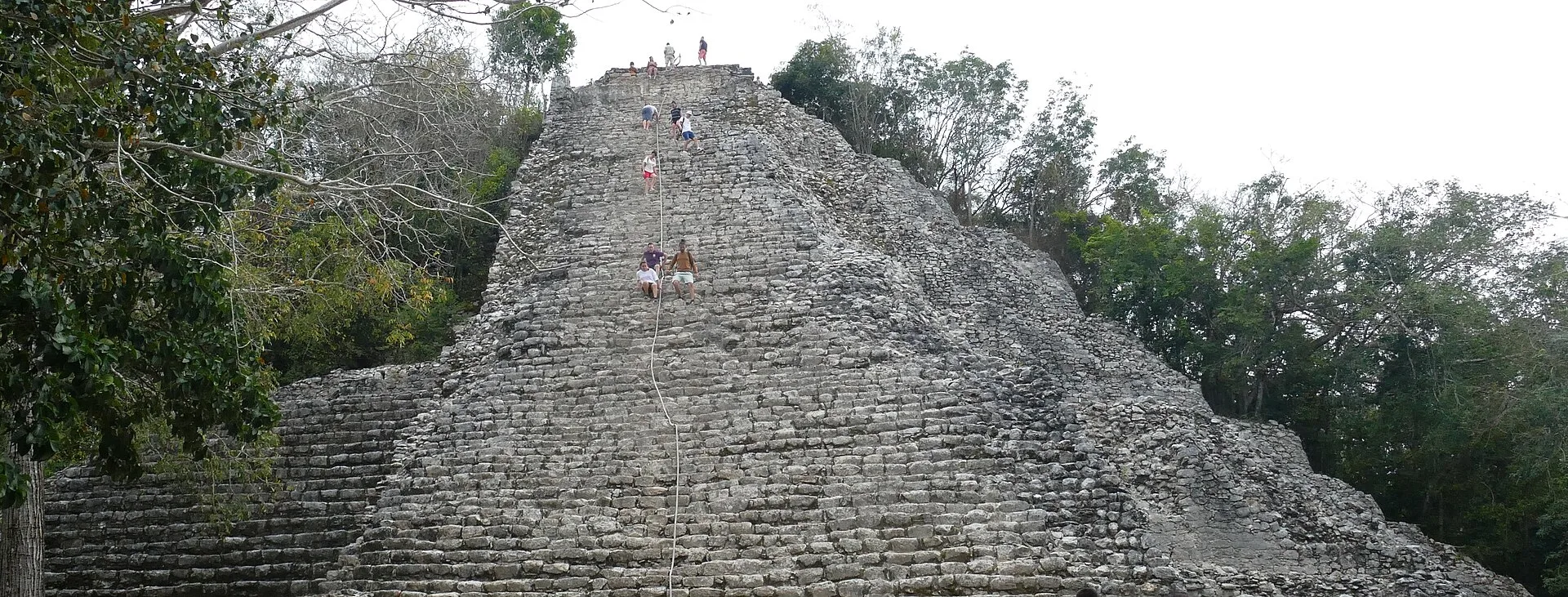 Visitors climb Nohoch Mul in a wide documentary photograph made in 2020.