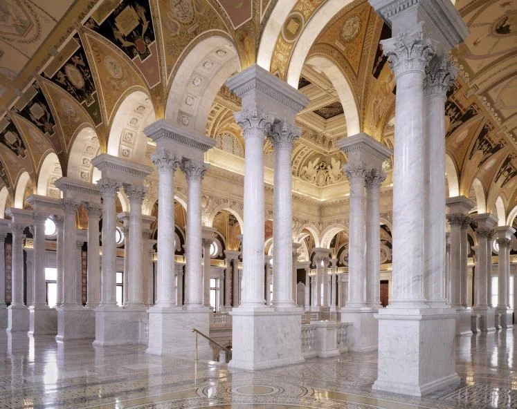 The Great Hall of the Library of Congress layers arches, columns, mosaics and inscriptions.